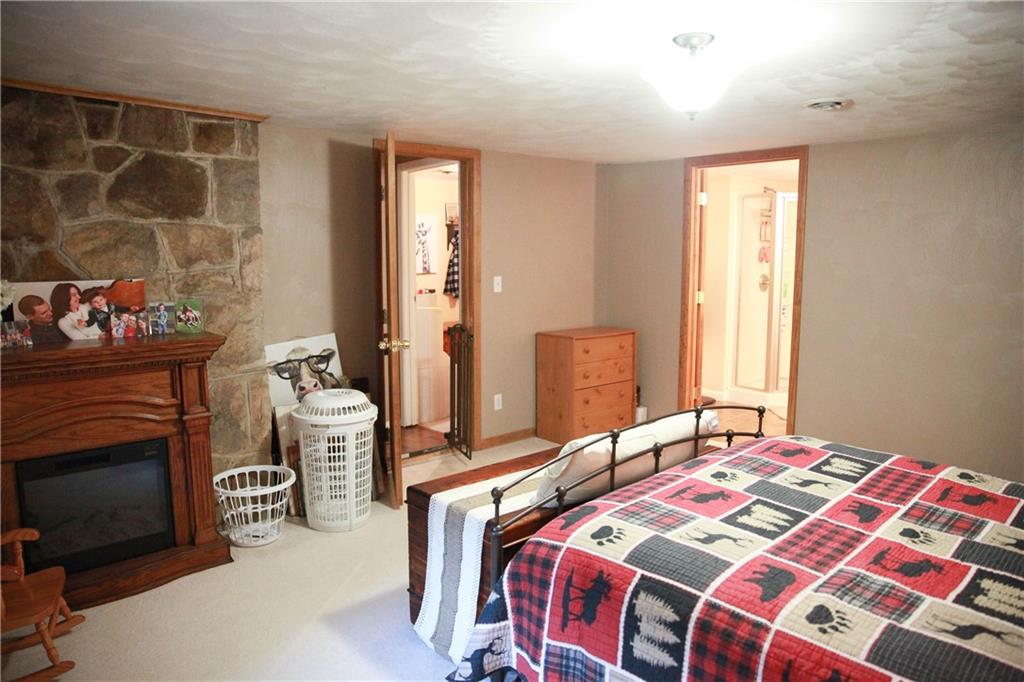 75 Spruce Peak Road Acme, PA 15610 - Photo 22 of 25 a bedroom with a bed and a mirror
