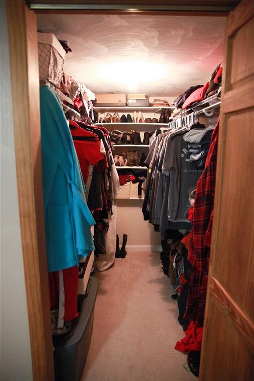 75 Spruce Peak Road Acme, PA 15610 - Photo 23 of 25 a view of walk in closet with clothes and shoes