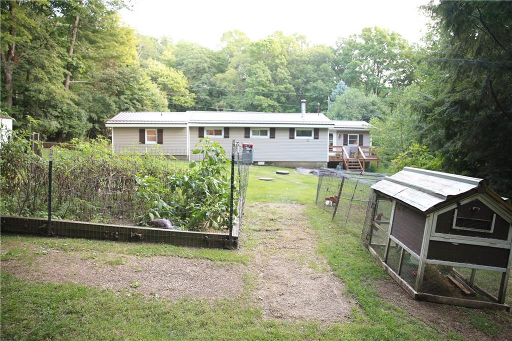 75 Spruce Peak Road Acme, PA 15610 - Photo 5 of 25 a view of a house with backyard porch and sitting area