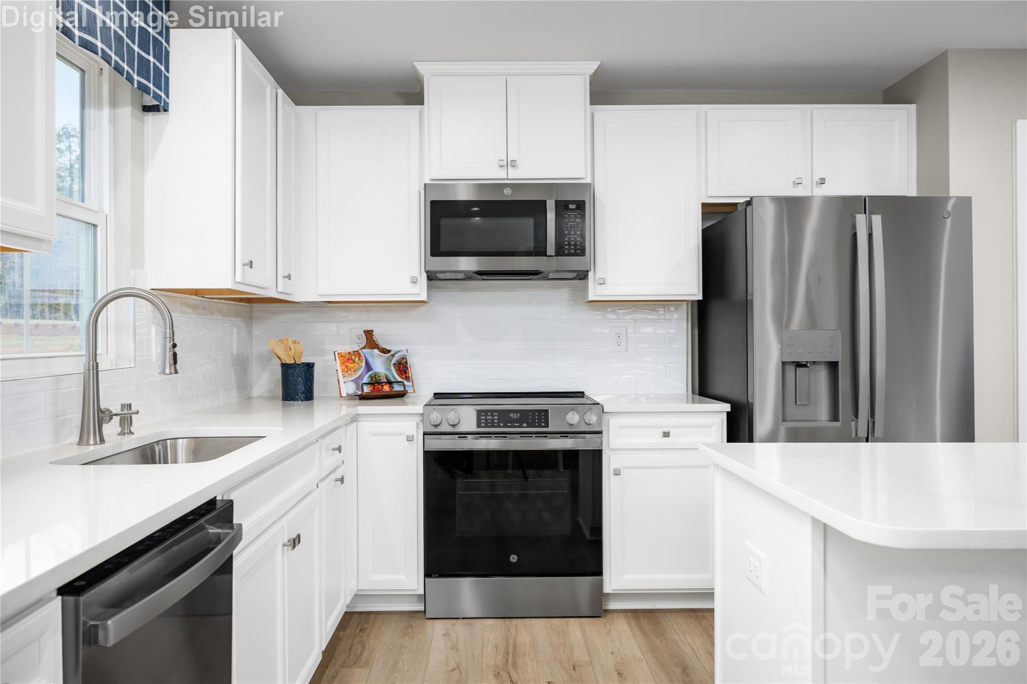 3290 Eller Drive Extension Hickory, NC 28602 - Photo 2 of 21 a kitchen with stainless steel appliances granite countertop a sink stove and refrigerator