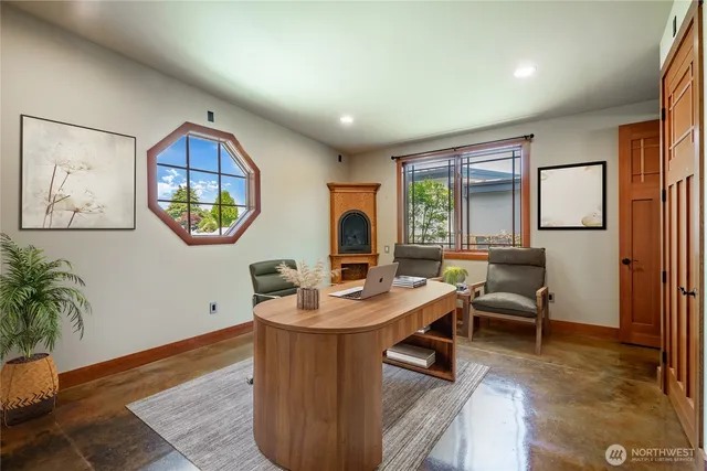 a living room with furniture a window and a potted plant