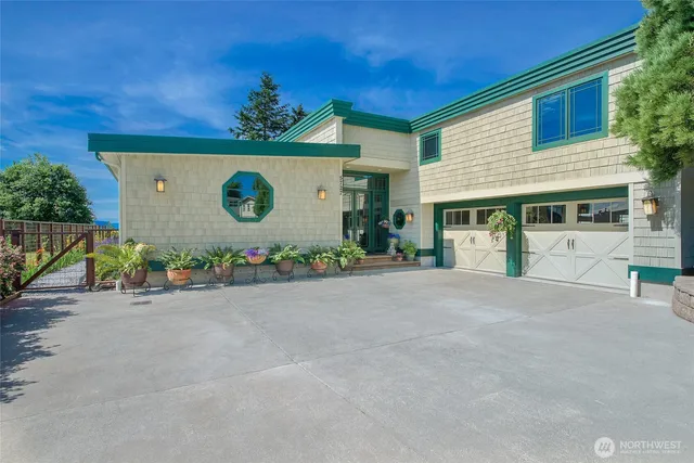 a front view of a house with a yard and a garage