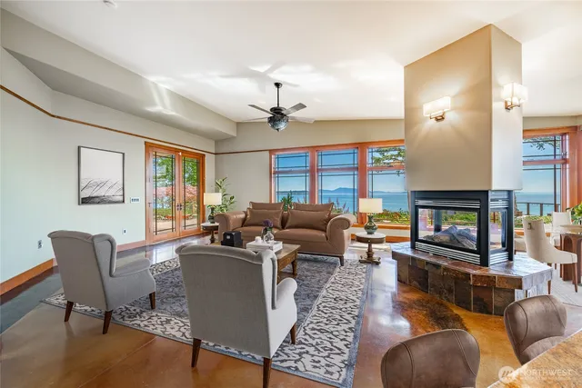 a living room with furniture a fireplace and a window