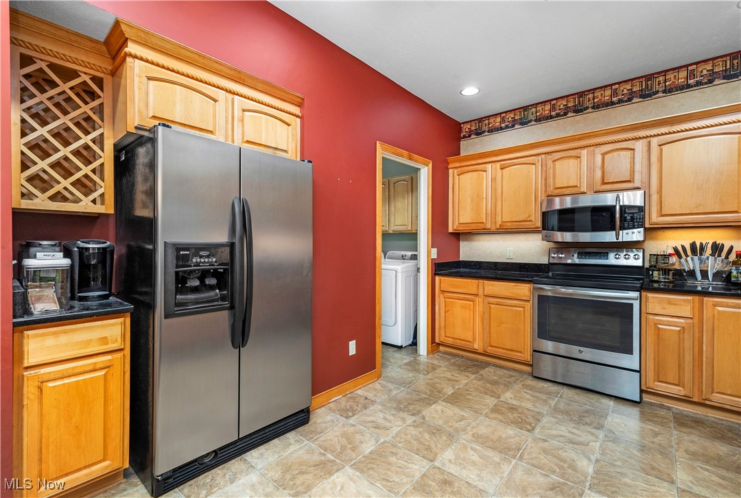 177 Mishler Road Mogadore, OH 44260 - Photo 13 of 50 Kitchen with appliances with stainless steel finishes, a breakfast bar, granite counter tops, great cabinet space, great counter space and a pantry