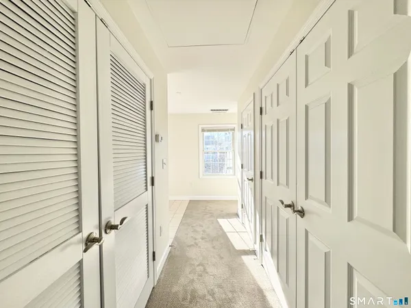a view of a hallway with a white door