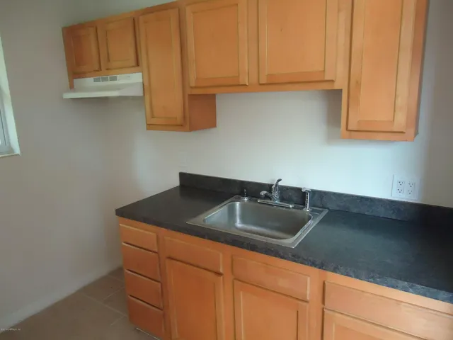 a kitchen with stainless steel appliances granite countertop white cabinets sink and dishwasher
