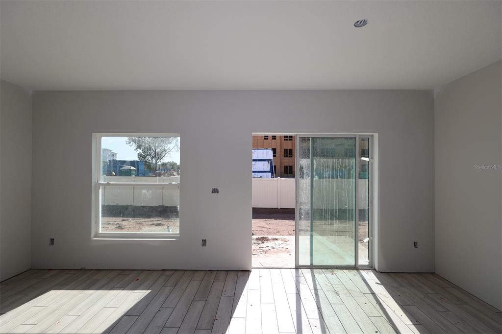 4116 Campsite Loop Orlando, FL 32824 - Photo 4 of 10 a view of room with window and wooden floor