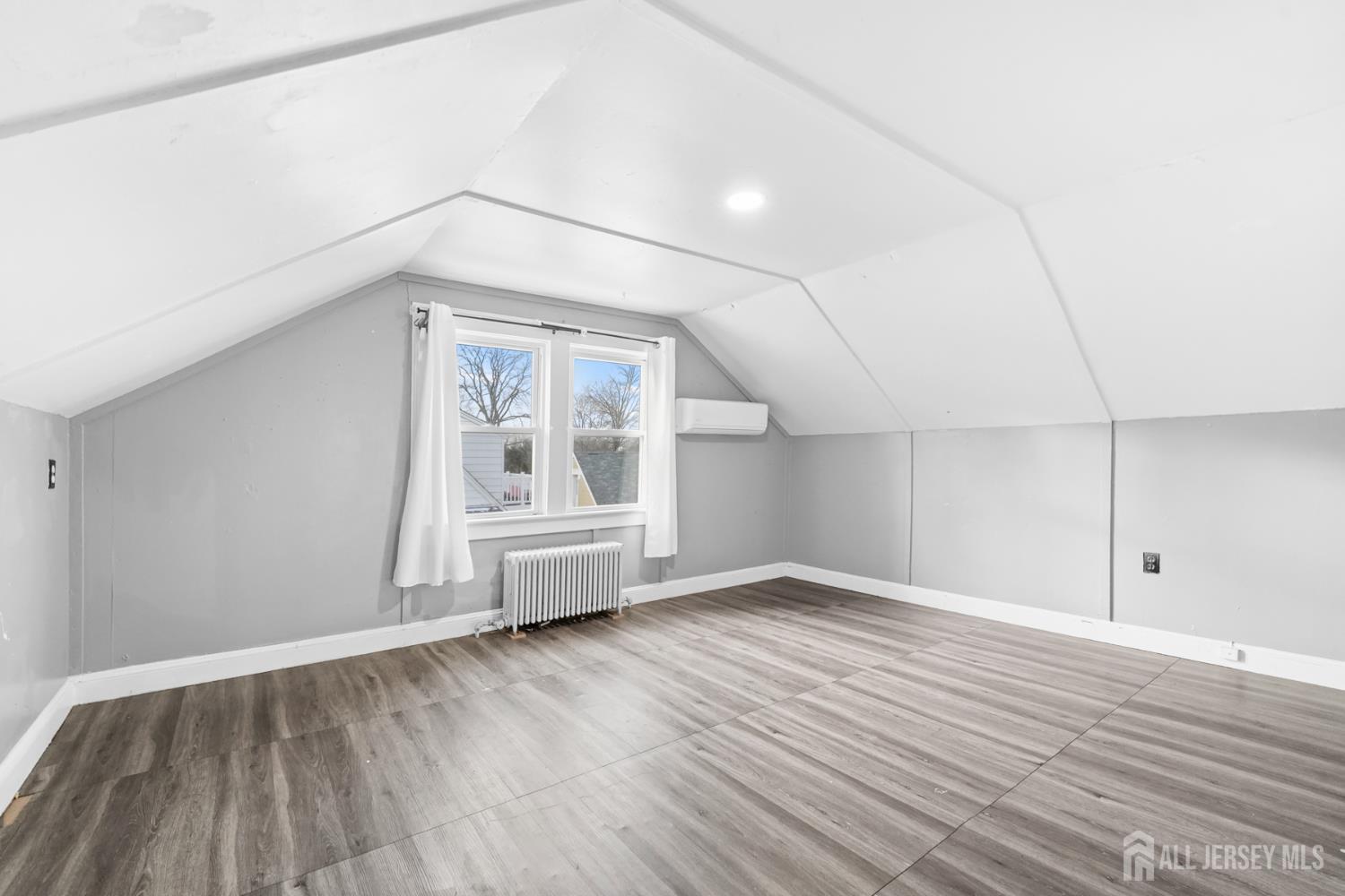 339 Plainsboro Road Plainsboro, NJ 08536 - Photo 12 of 16 an empty room with wooden floor and windows