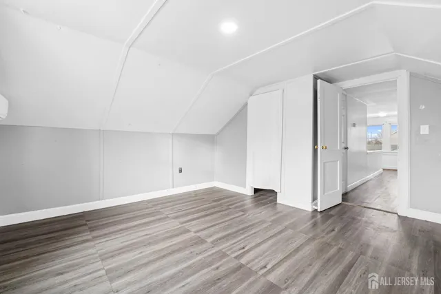 a view of a room with wooden floor