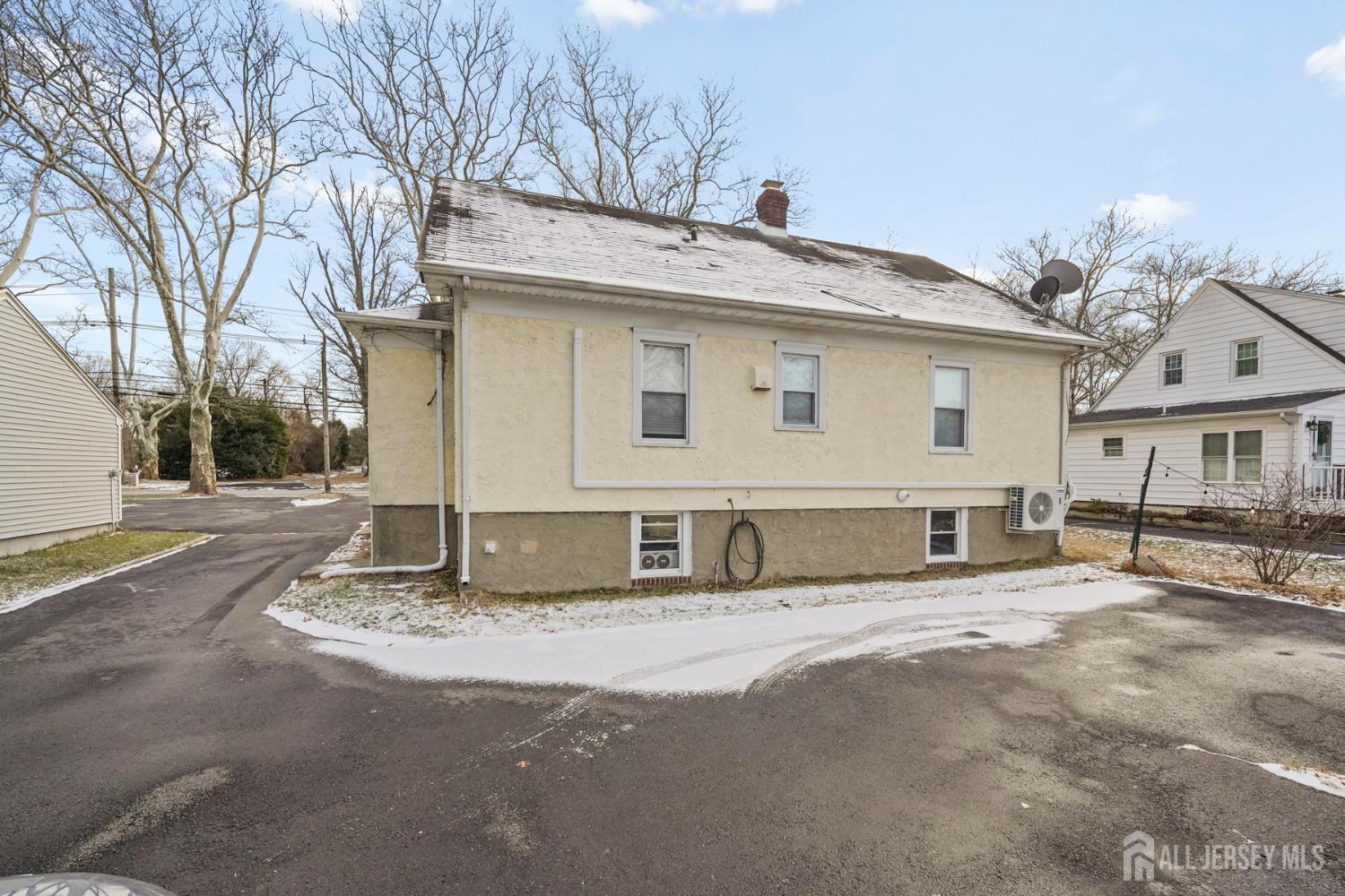 339 Plainsboro Road Plainsboro, NJ 08536 - Photo 16 of 16 a view of a house with a large tree and wooden fence