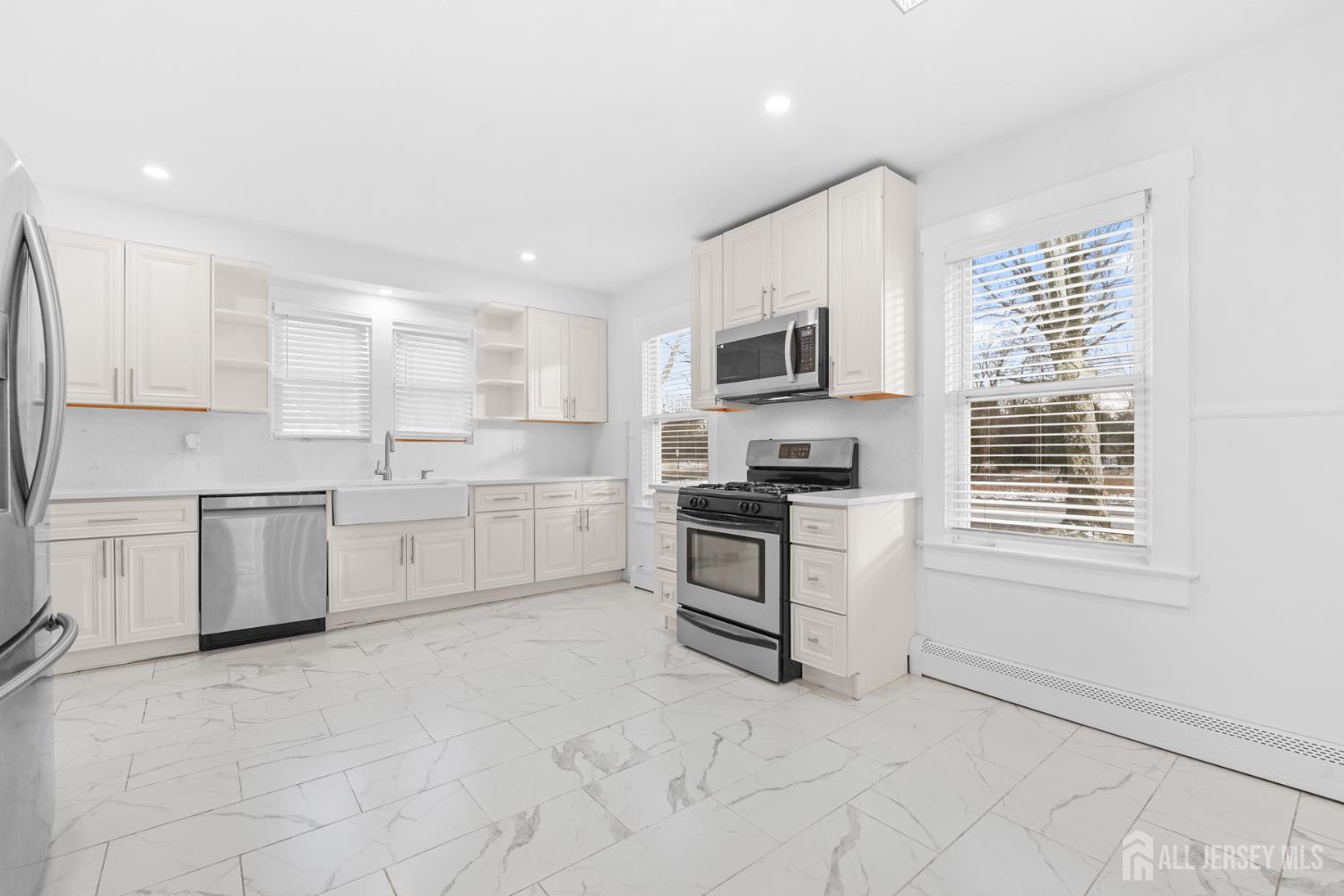 339 Plainsboro Road Plainsboro, NJ 08536 - Photo 3 of 16 a kitchen with white cabinets and appliances