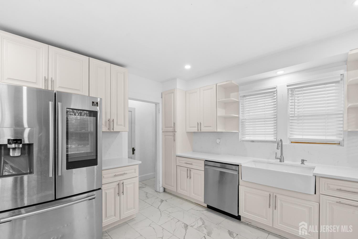 339 Plainsboro Road Plainsboro, NJ 08536 - Photo 4 of 16 a kitchen with a refrigerator sink and cabinets