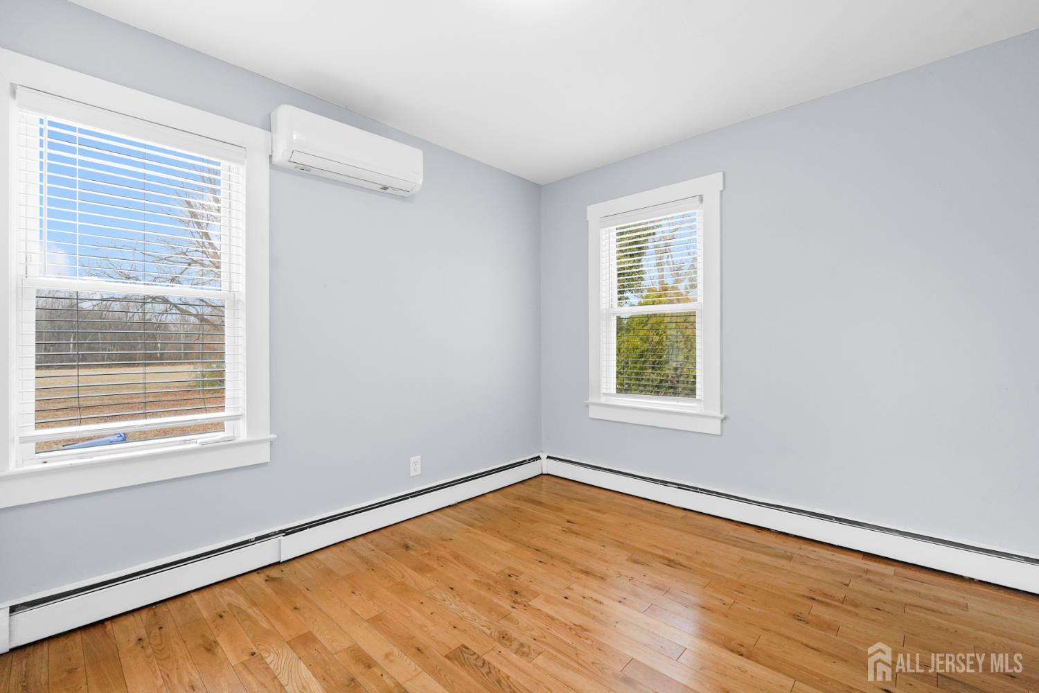 339 Plainsboro Road Plainsboro, NJ 08536 - Photo 5 of 16 a view of an empty room with wooden floor and a window