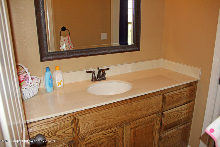 1041 Copper Ridge Bushland, TX 79124 - Photo 27 of 46 a bathroom with a sink and a mirror