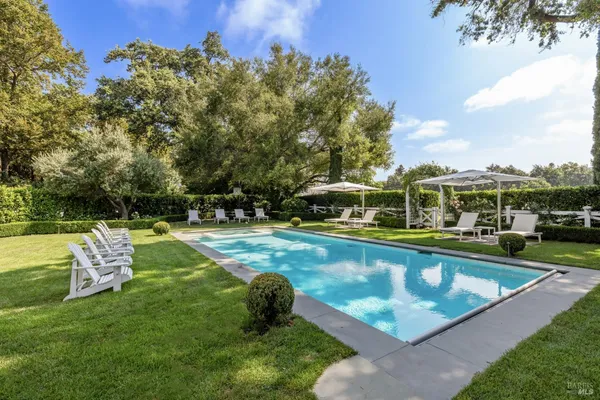 a view of a swimming pool with a yard