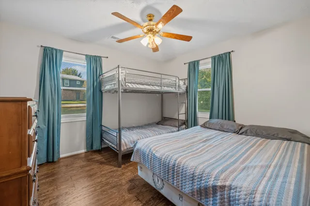 a bedroom with a bed and a ceiling fan
