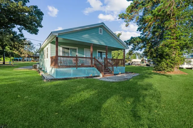 a front view of a house with a garden