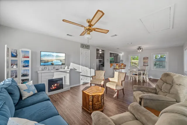 a living room with furniture fireplace and a large window