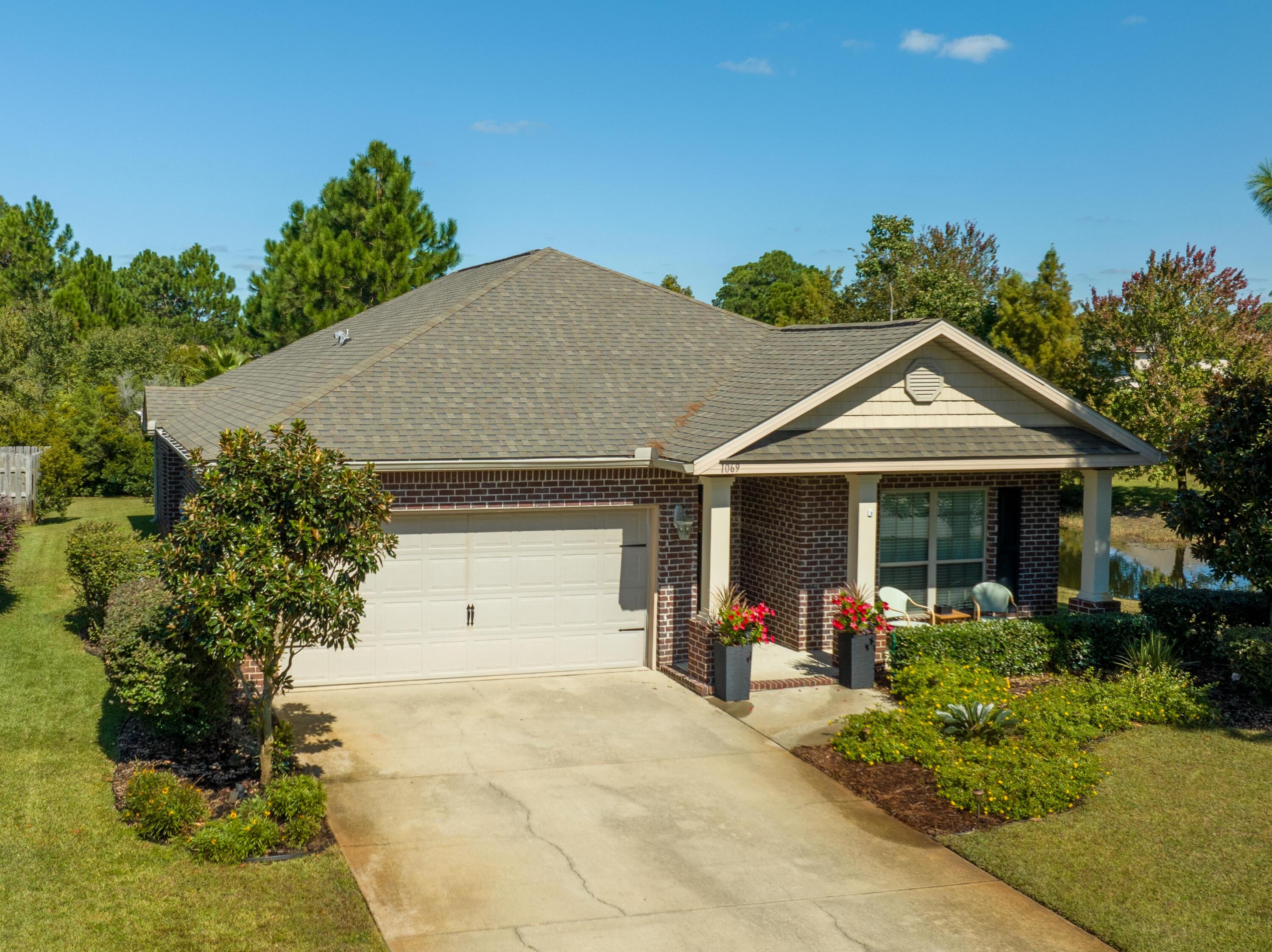 1069 Cocobolo Drive Santa Rosa Beach, FL 32459 - Photo 2 of 46 a view of a house with yard and plants