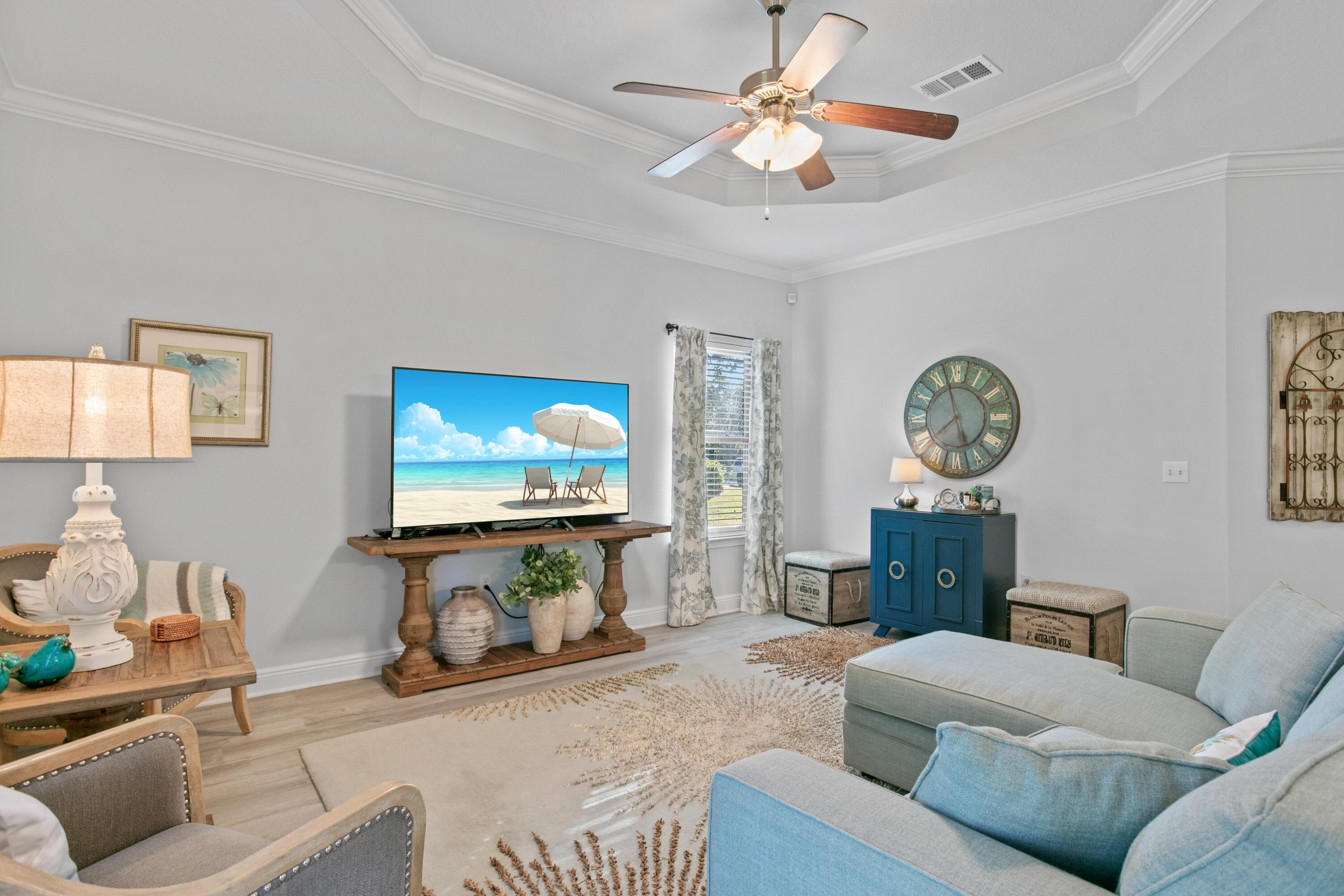 1069 Cocobolo Drive Santa Rosa Beach, FL 32459 - Photo 23 of 46 a living room with furniture and a flat screen tv