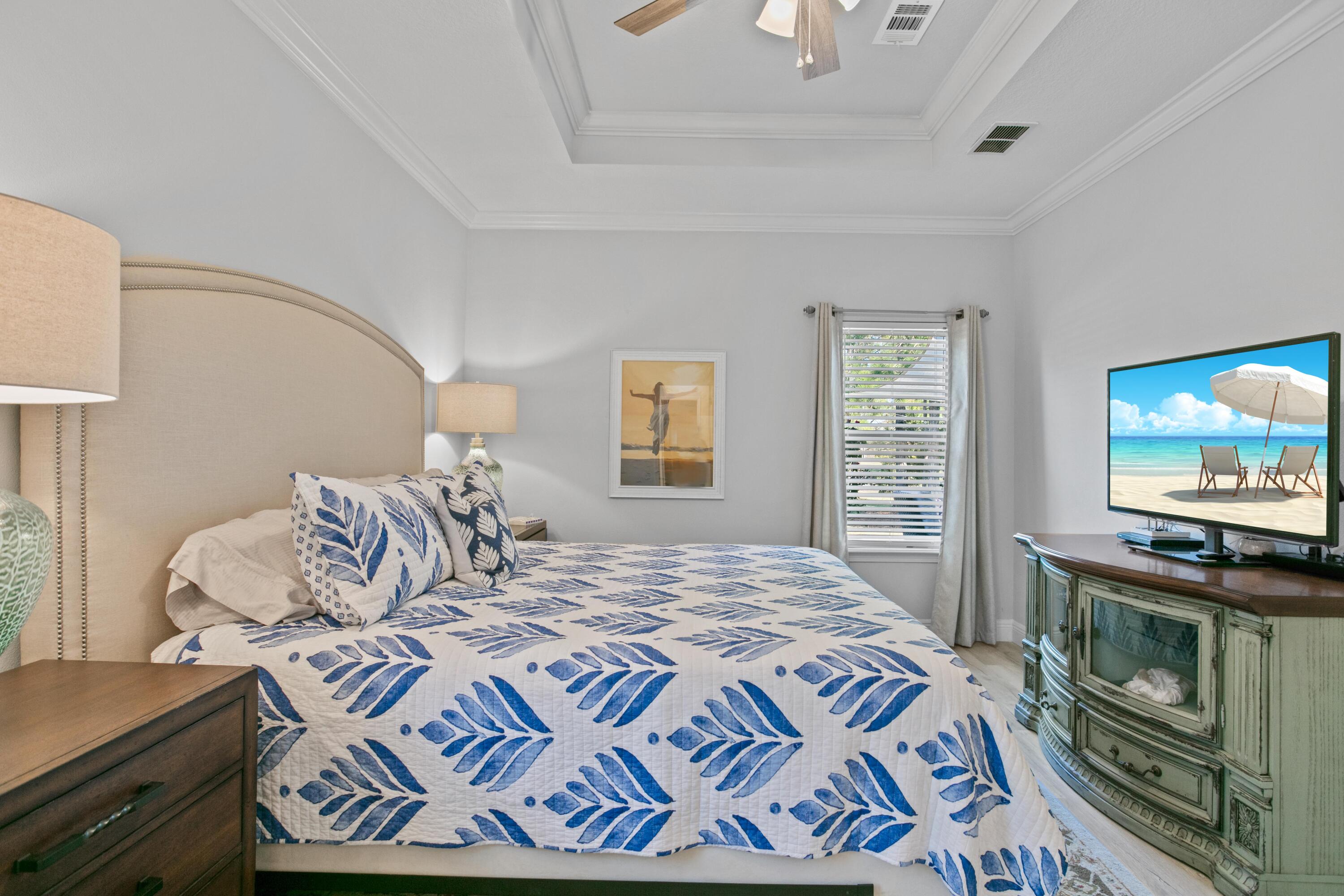 1069 Cocobolo Drive Santa Rosa Beach, FL 32459 - Photo 27 of 46 a bedroom with a bed and a flat screen tv