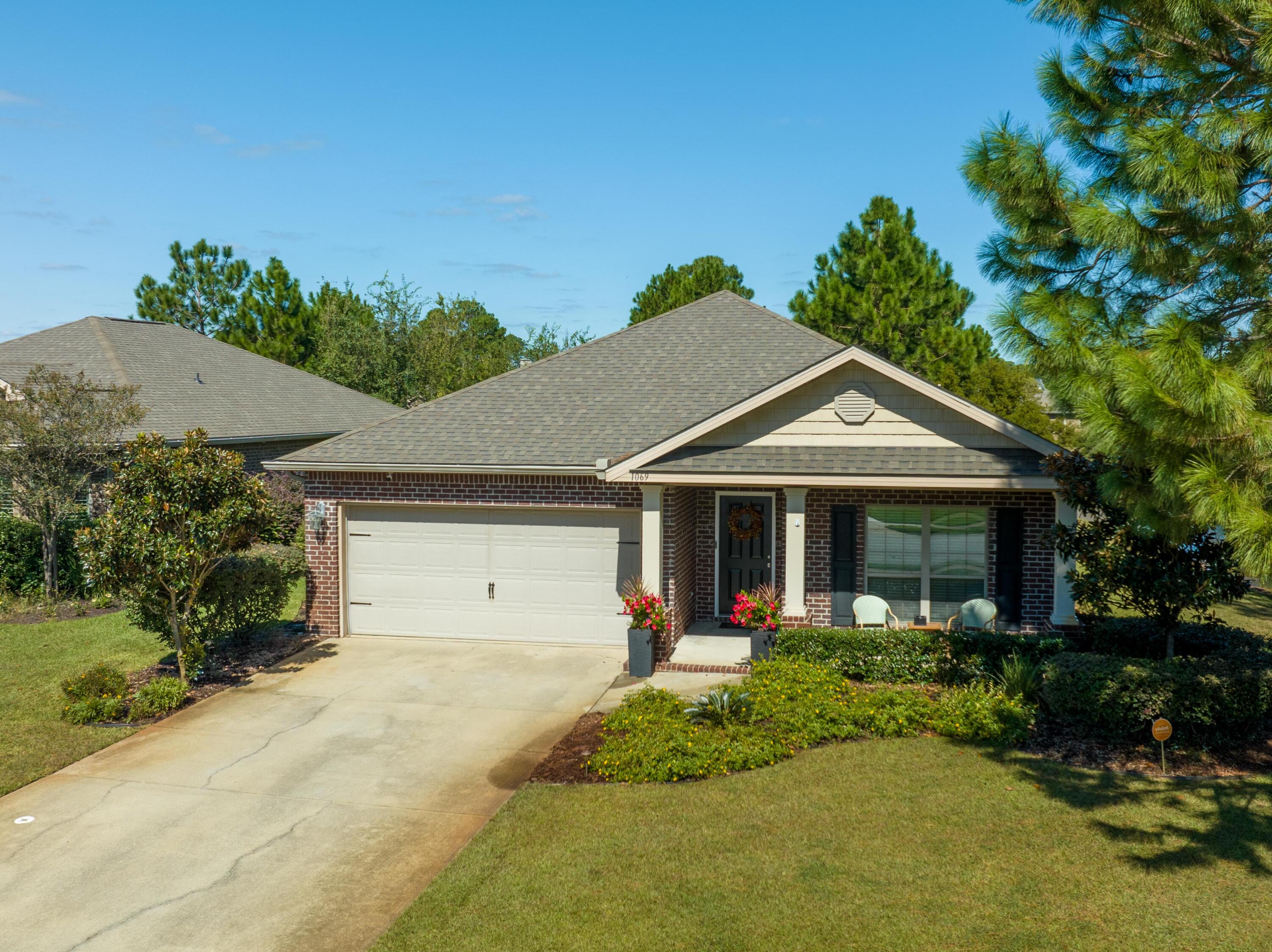 1069 Cocobolo Drive Santa Rosa Beach, FL 32459 - Photo 3 of 46 a front view of a house with garden