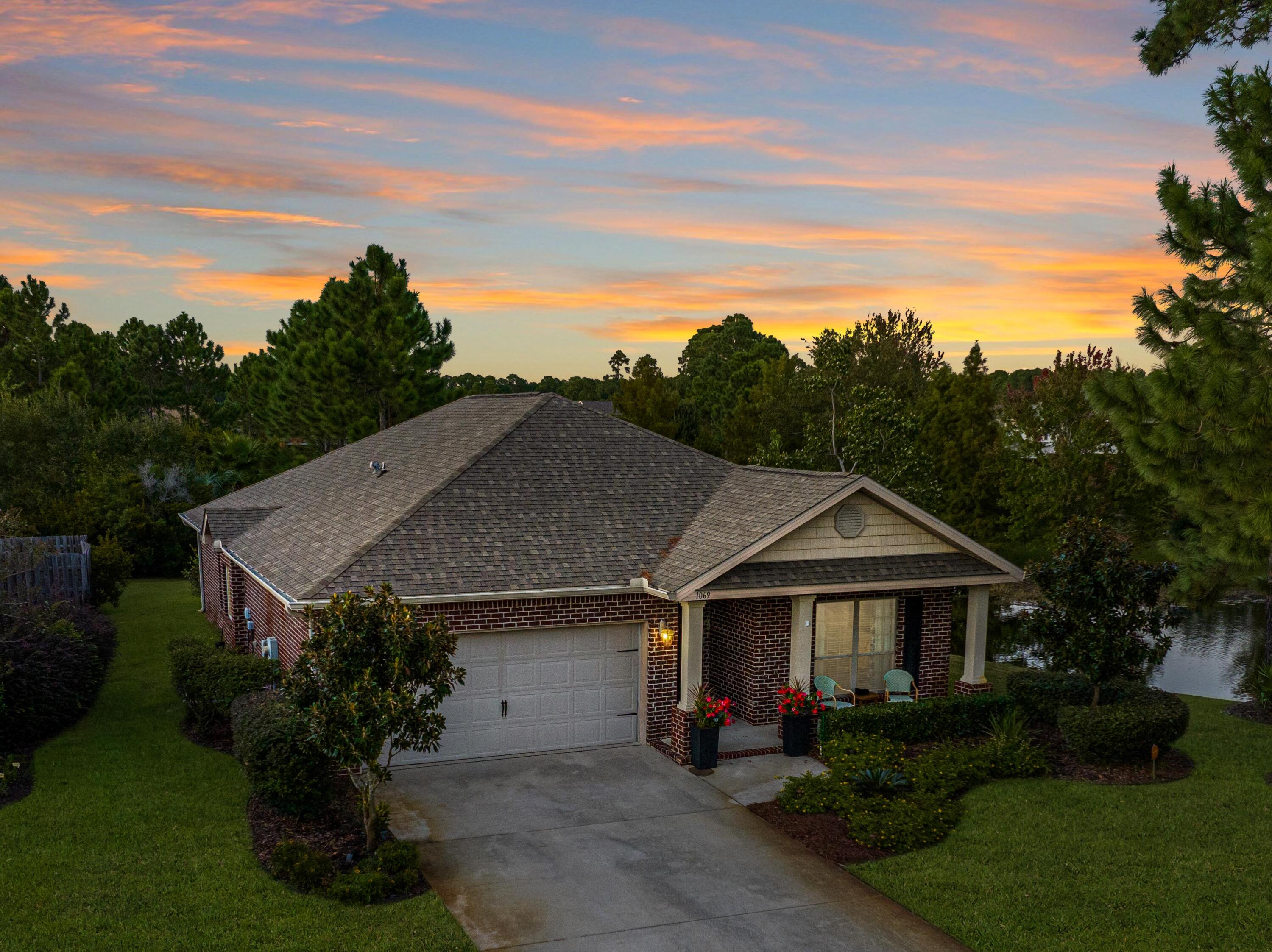 1069 Cocobolo Drive Santa Rosa Beach, FL 32459 - Photo 5 of 46 a front view of a house with a garden