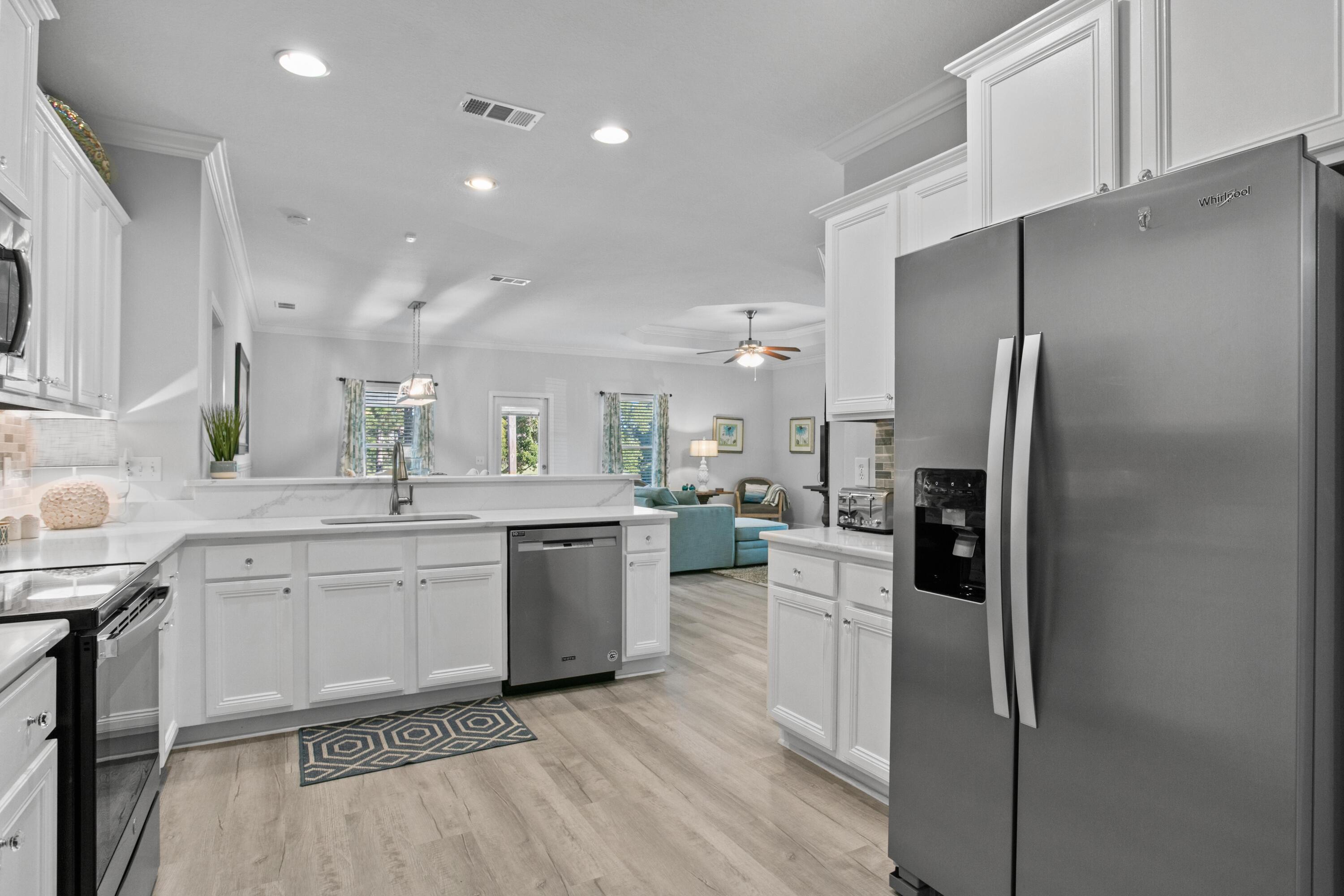 1069 Cocobolo Drive Santa Rosa Beach, FL 32459 - Photo 10 of 46 a kitchen with a sink stainless steel appliances and cabinets