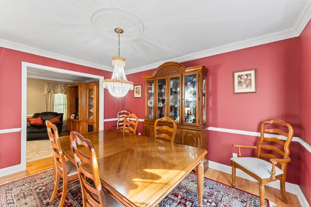 a view of a dining room with furniture and chandelier
