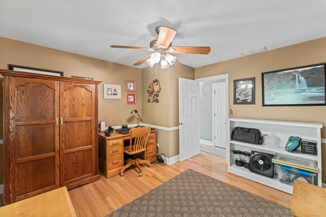 a view of a workspace with furniture and a window