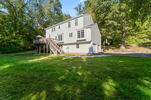 a view of backyard of house with green space