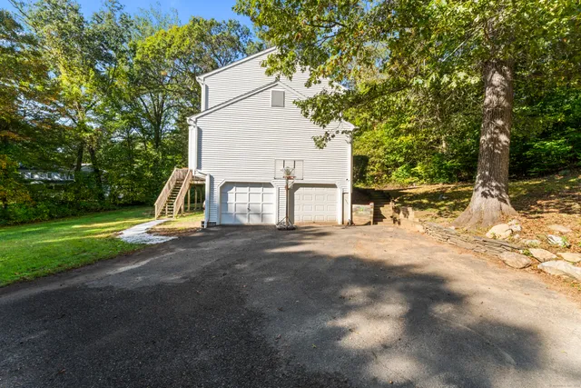 a view of a house with a yard and sitting area