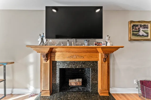 a living room with a fireplace and a flat screen tv