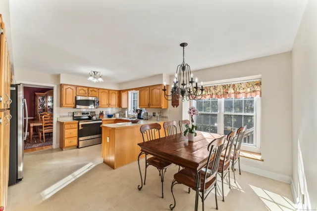 a view of a dining room with furniture and chandelier
