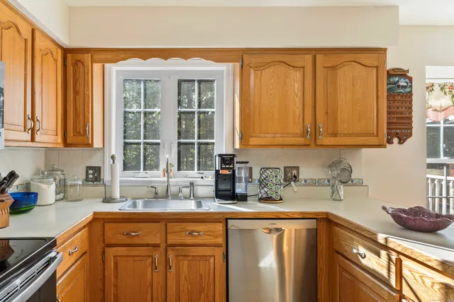 a kitchen with stainless steel appliances granite countertop a sink and cabinets