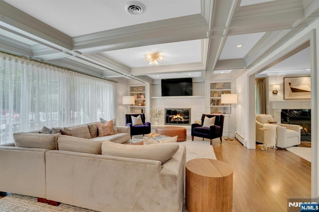 48 Hopper Farm Road Upper Saddle River, NJ 07458 - Photo 8 of 43 a living room with furniture a fireplace and a flat screen tv