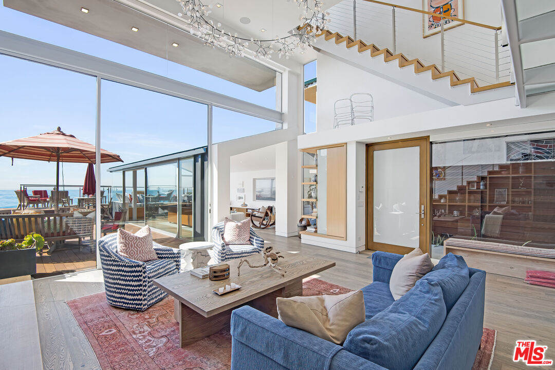 23536 Malibu Colony Road Malibu, CA 90265 - Photo 12 of 44 a living room with furniture and a floor to ceiling window