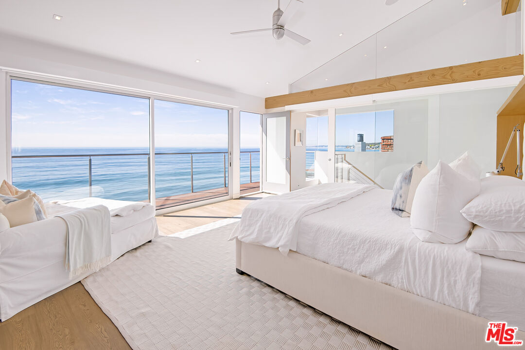 23536 Malibu Colony Road Malibu, CA 90265 - Photo 15 of 44 a bedroom with a large bed and a large window