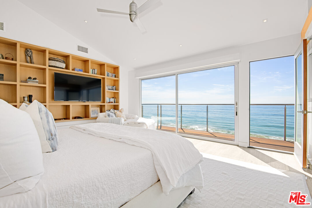 23536 Malibu Colony Road Malibu, CA 90265 - Photo 16 of 44 a bedroom with a large bed and a large window