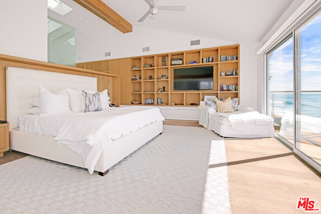 23536 Malibu Colony Road Malibu, CA 90265 - Photo 17 of 44 a bedroom with a large bed and a large window