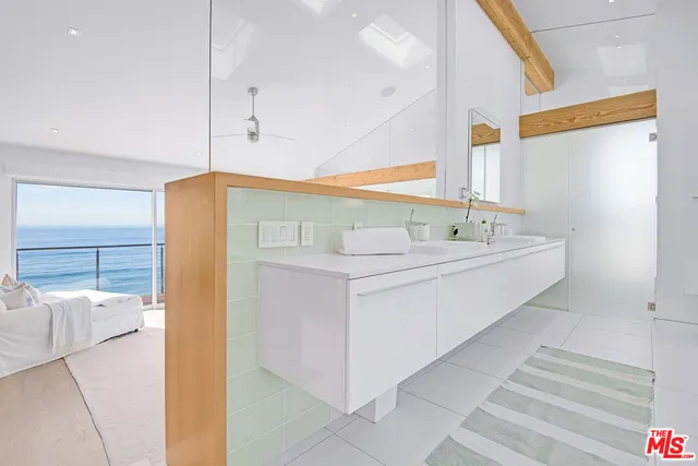 a bathroom with a double vanity sink mirror and