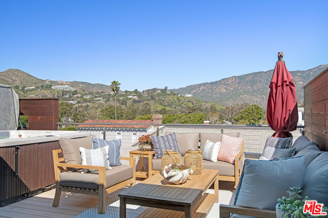 23536 Malibu Colony Road Malibu, CA 90265 - Photo 23 of 44 a view of a terrace with couches and wooden fence