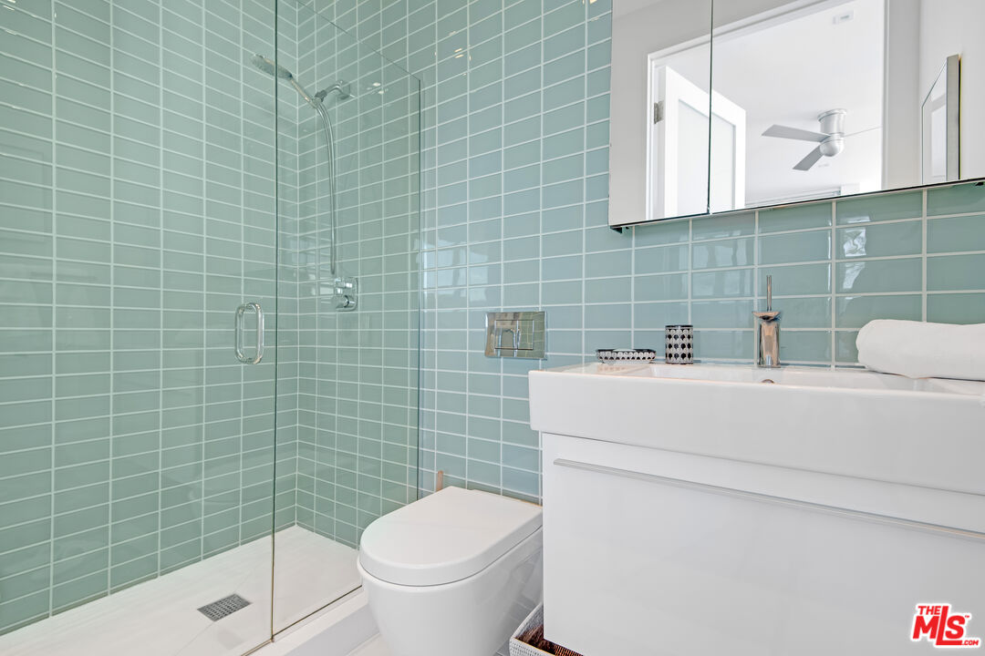 23536 Malibu Colony Road Malibu, CA 90265 - Photo 35 of 44 a bathroom with a sink a toilet and a mirror