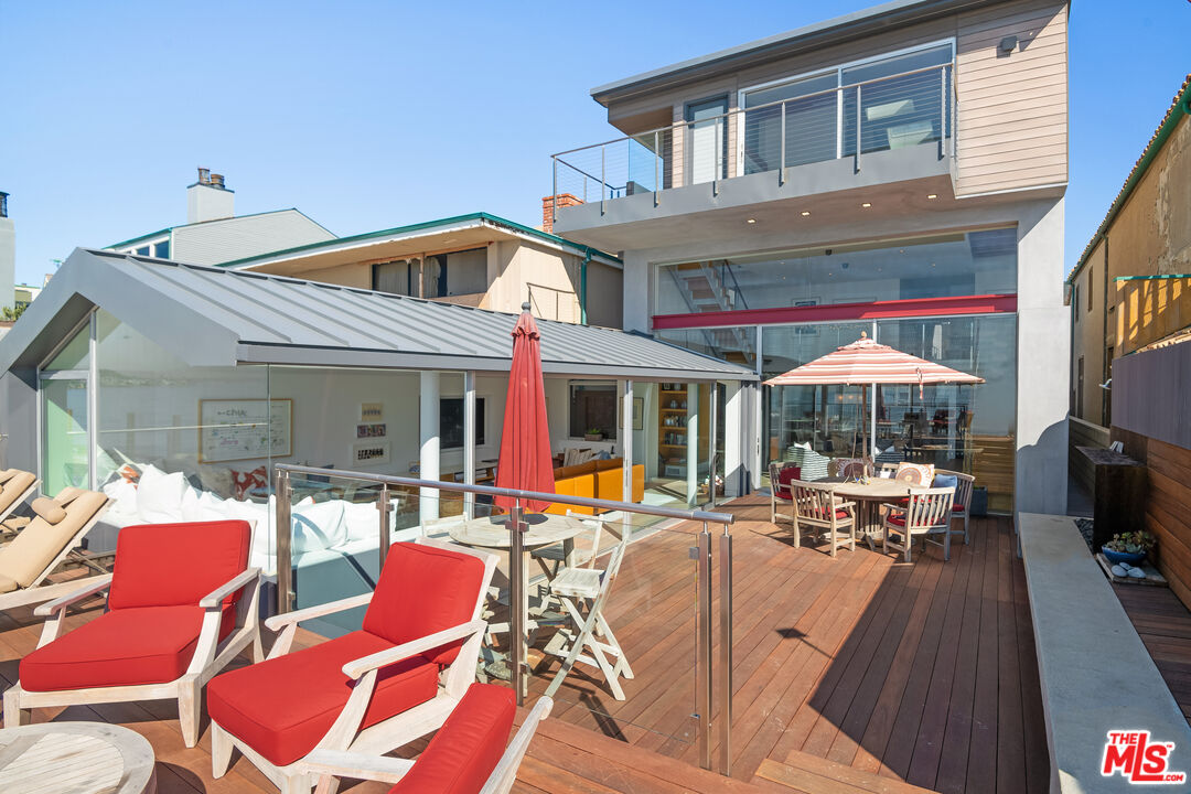 23536 Malibu Colony Road Malibu, CA 90265 - Photo 4 of 44 a view of a patio with table and chairs under an umbrella