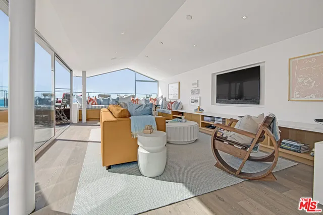 a living room with lots of furniture and a flat screen tv