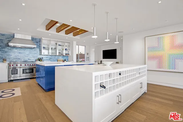 a kitchen with stainless steel appliances a stove a sink and a refrigerator