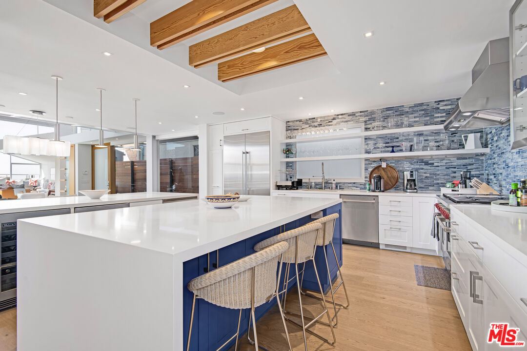 23536 Malibu Colony Road Malibu, CA 90265 - Photo 9 of 44 a kitchen with stainless steel appliances granite countertop a sink a stove and a refrigerator