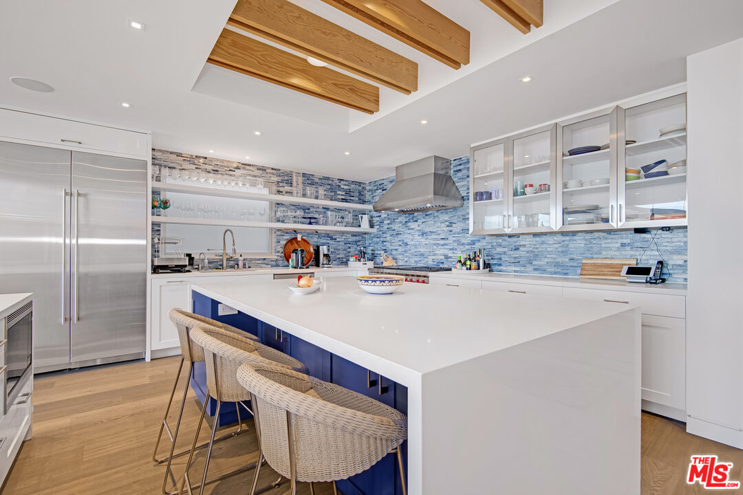 23536 Malibu Colony Road Malibu, CA 90265 - Photo 10 of 44 a kitchen with a sink a refrigerator and cabinets