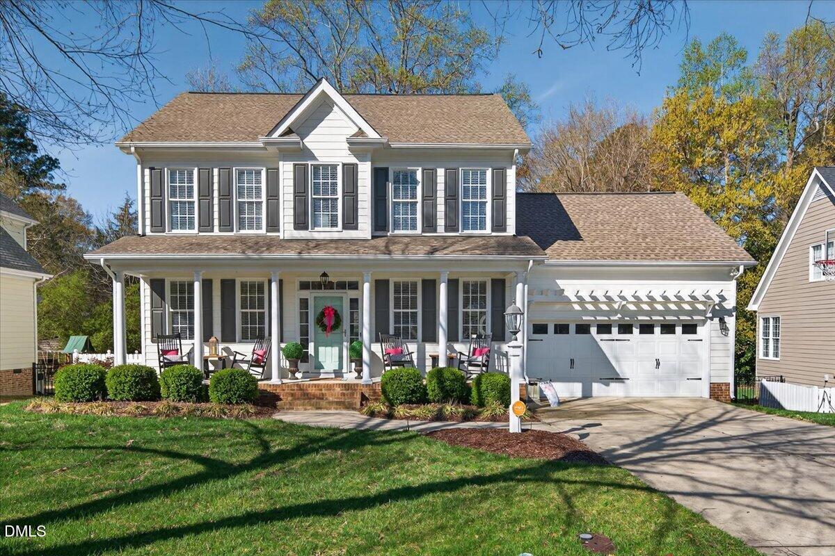 a front view of a house with garden and porch