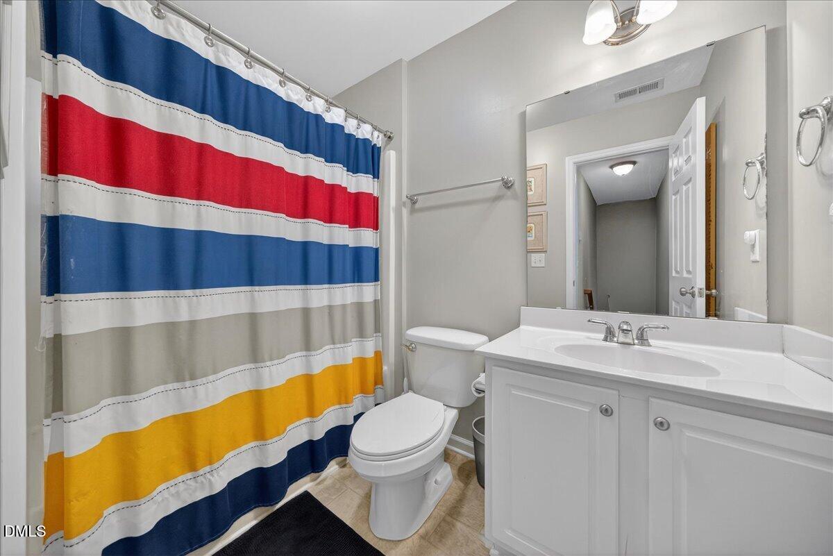 517 Lemon Pepper Place Wendell, NC 27591 - Photo 12 of 19 a bathroom with a sink a toilet and shower